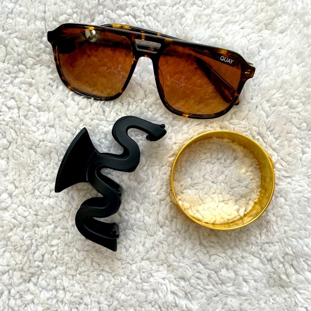 Coach gold bracelet. Quay sun glasses. Black hair clip.